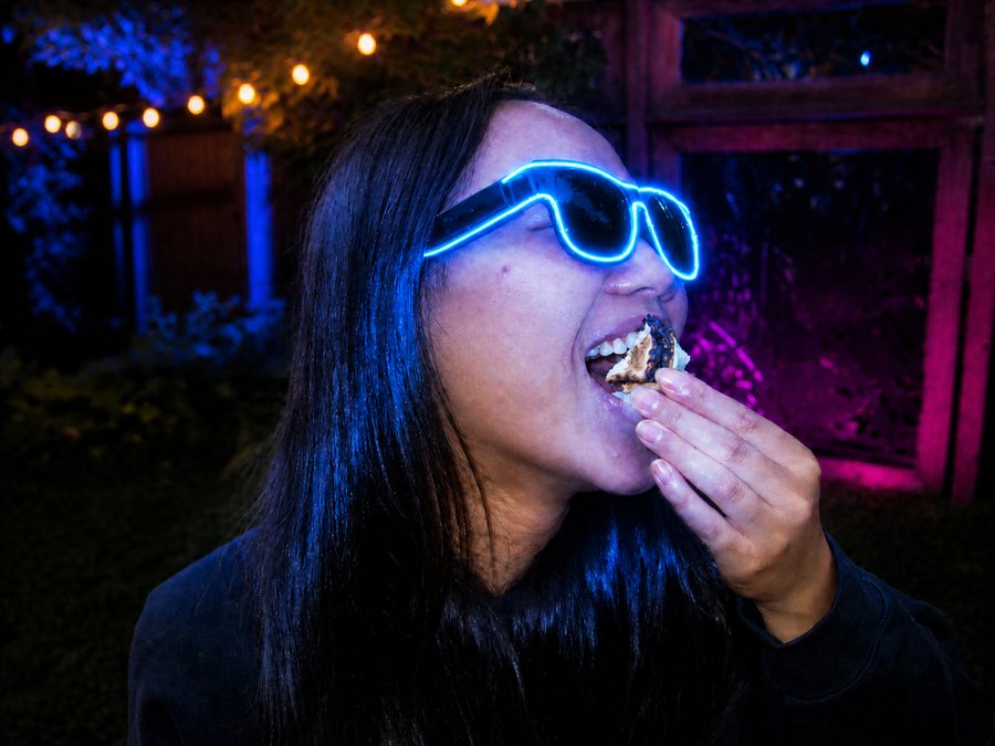 Group of friends wearing Sunglasses At Night in orange, pink, and blue