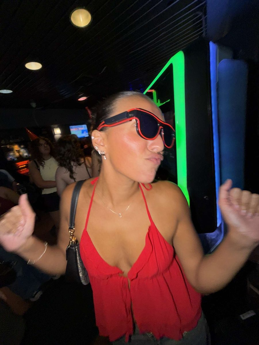 Woman dancing in a bar wearing red Sunglasses At Night LED glasses